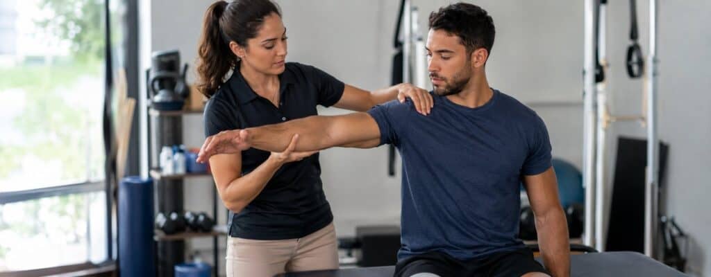 Sports physical therapist performing a shoulder assessment on an athlete